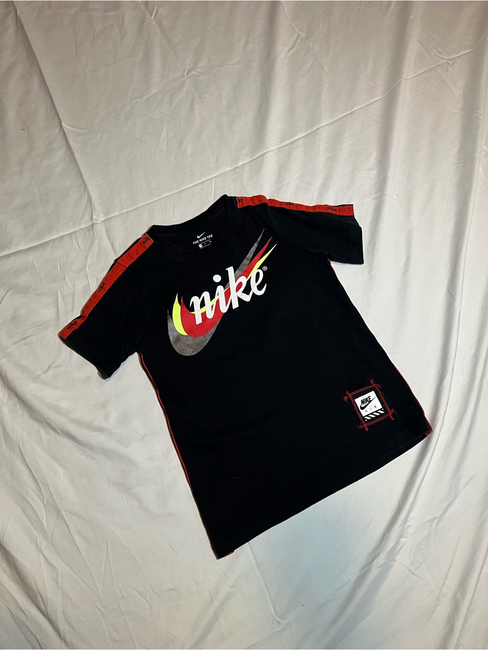 Nike Kids Black Tee with Multicolor Swoosh and Red Trim